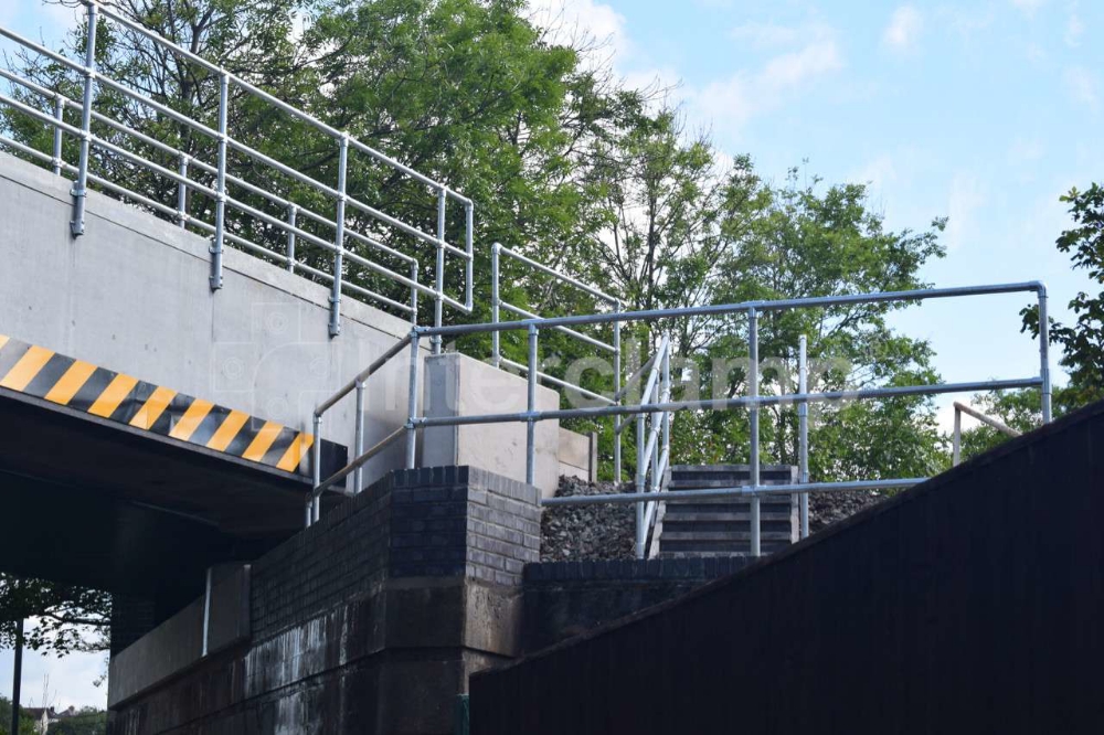 Guardrailing made with Interclamp key clamp fittings installed along a replacement railway bridge, offering robust protection for construction personnel.